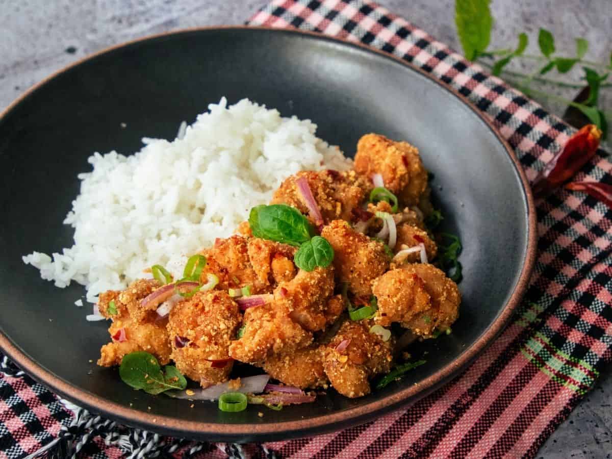 a bowl of spicy chicken rice bowl